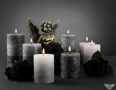 Ein Engel inmitten brennender Kerzen und schwarzer Rosen auf einem hellen Hintergrund. Symbol für Gedenken, Trauer und Frieden.